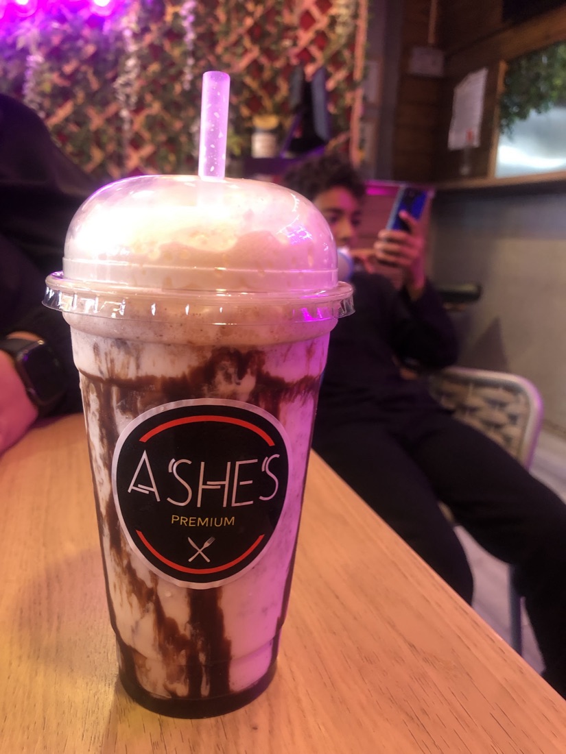 Peri peri grilled chicken burger with fries on an Ashes branded plate